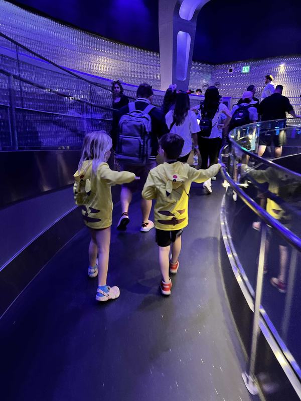 Mia and Bennett in the queue of Test Track at EPCOT