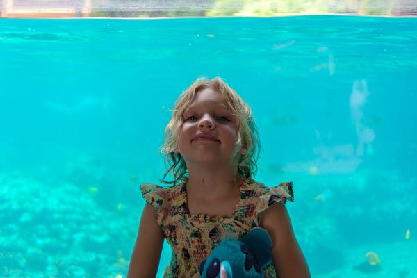 Mia in the viewing area of the snorkel pool at Aulani