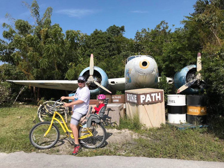 James with Mia on a bike on Castaway Cay in the Bahamas