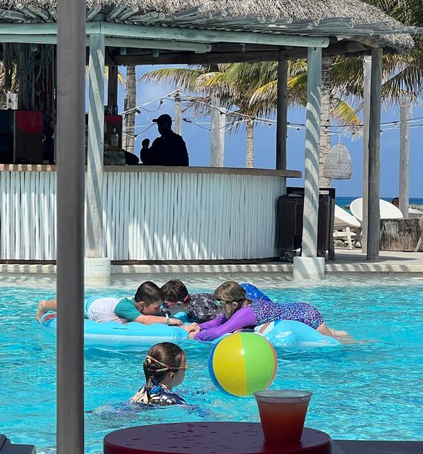 Mia, Bennett, and Tavasz in the pool at the beach club
