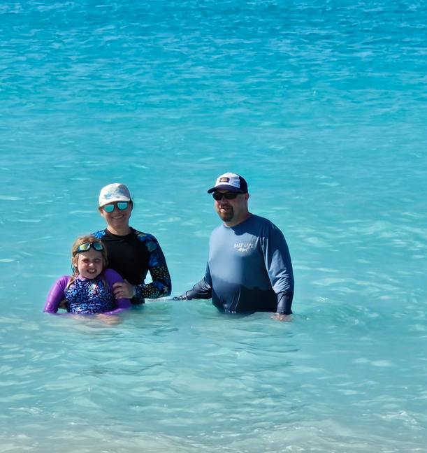 Mia, Kati, and James in the ocean near the beach in Bimini